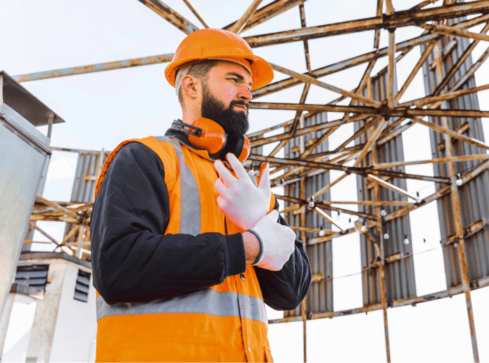 Construction Man Putting on Gloves